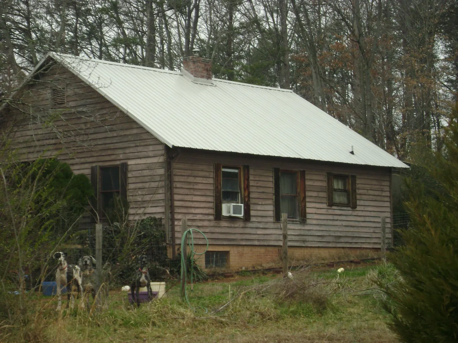 White metal roof on an old wood sided farmhouse, from a Asphalt Shingle Roof Repair job in Hanson